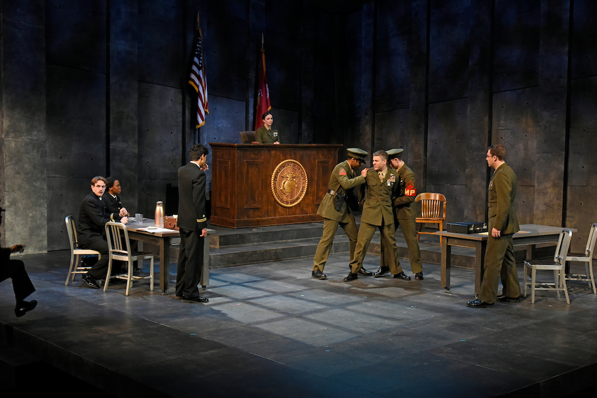 Several female actors on stage, dressed in period greek costumes.