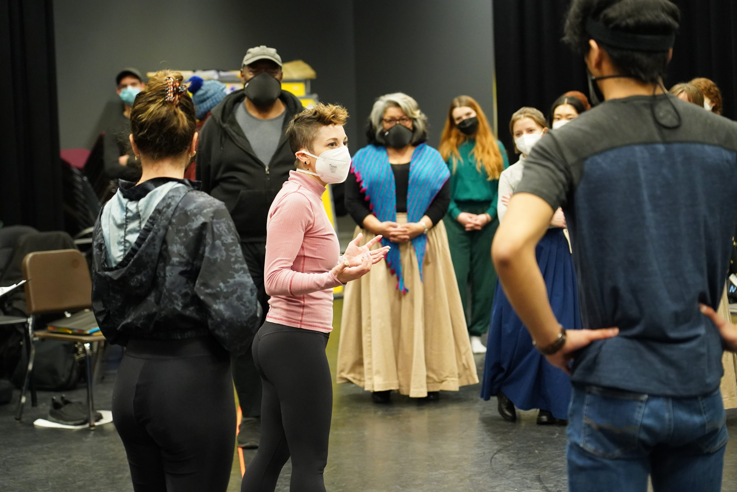 Choreographer Alison Solomon addresses Fiddler dancers; Chuck Cooper (Tevye) and Loretta Ables Sayre (Golde) stand to her left.