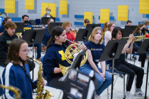 SMTD music education major Eden West (center, wearing mask) observes while the 8th graders practice.