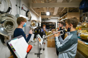 SMTD sophomore Josh Balough (left) works with Parker trumpet players (left to right) Jack S., Kalen B., and Jeffrey S.