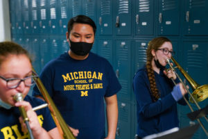 SMTD sophomore Johnny To (center) works with Parker trombone players Lily R. (left) and Katelyn C. (right).