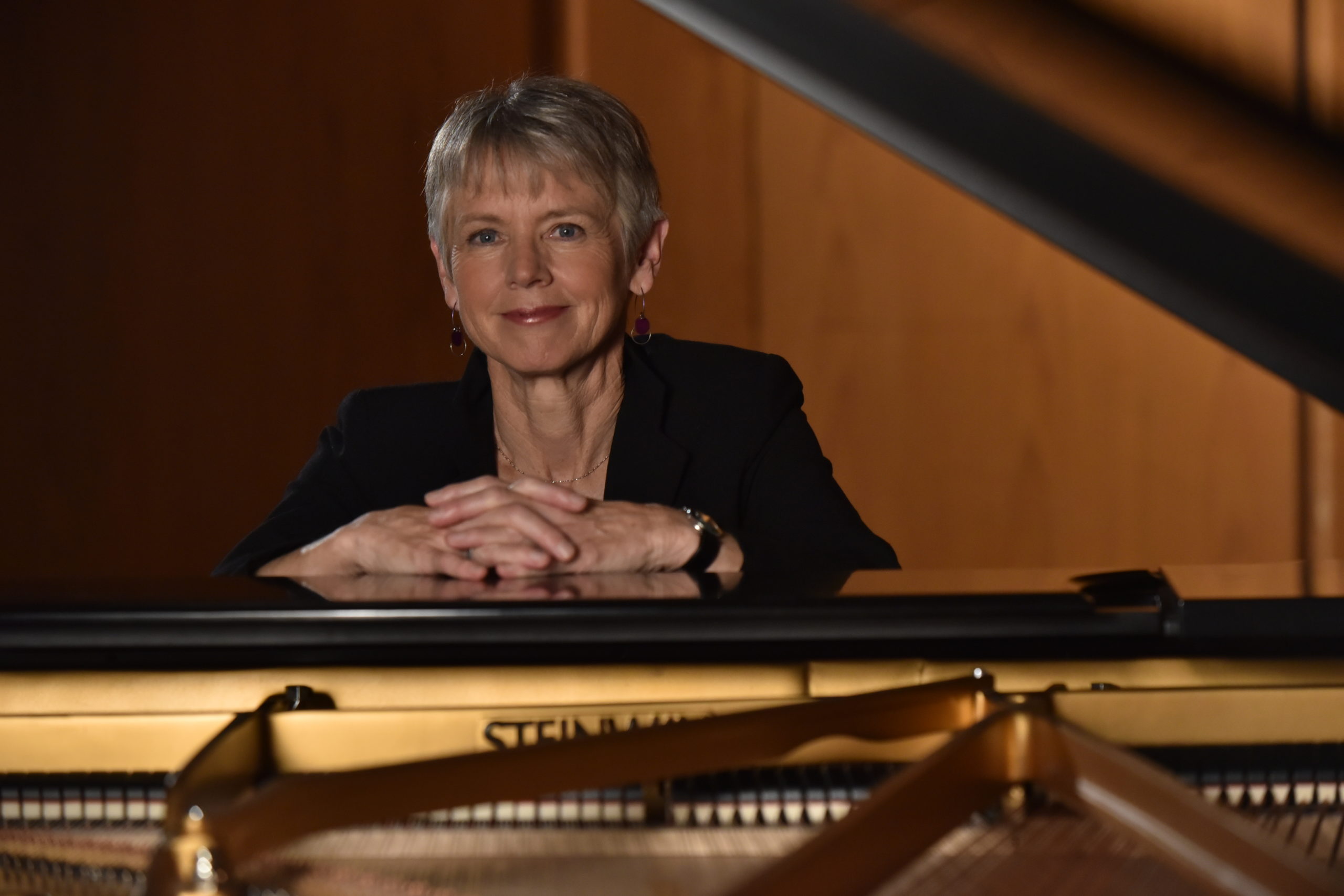 Ellen Rowe seated at a piano
