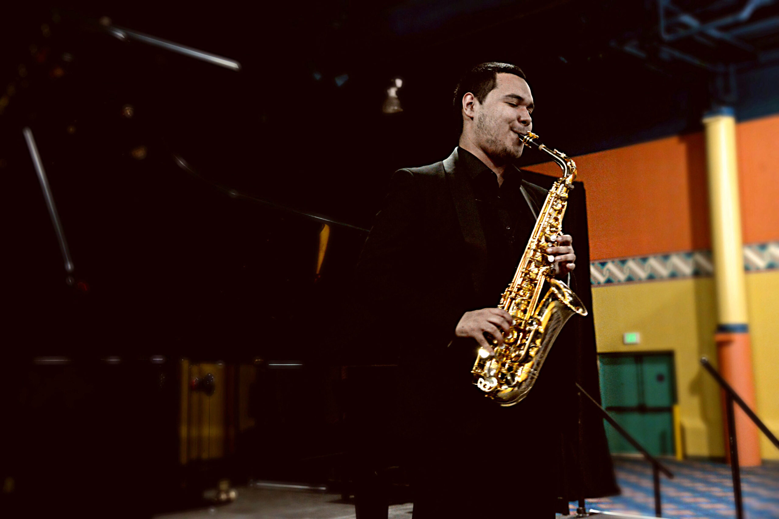Student Salvador Flores plays the saxophone