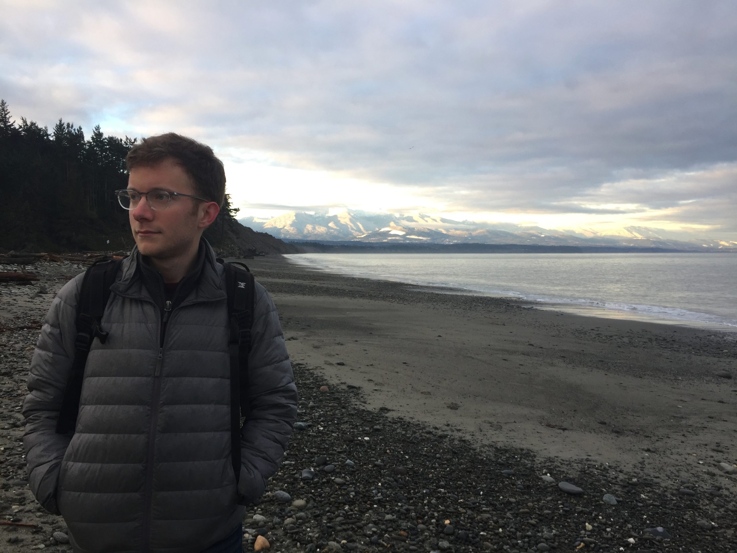 Michael standing at the edge of a large body of water.