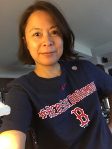 Casual photo of Christi-Anne Castro wearing a navy blue with red and white lettering, Boston Red Sox t-shirt.