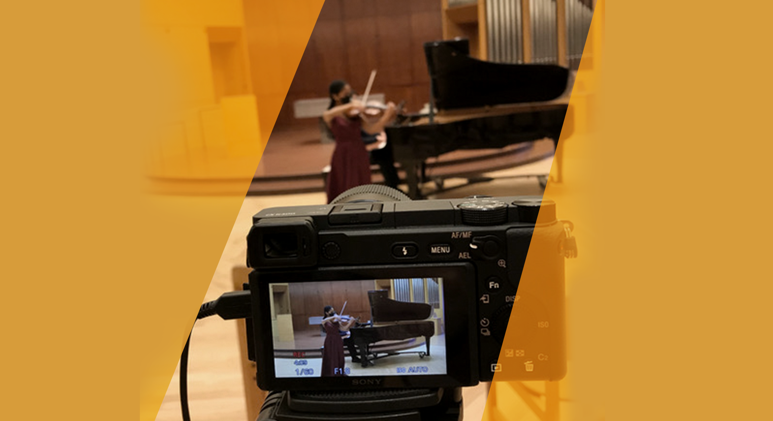 Photo of a string player with camera filming them in the foreground.