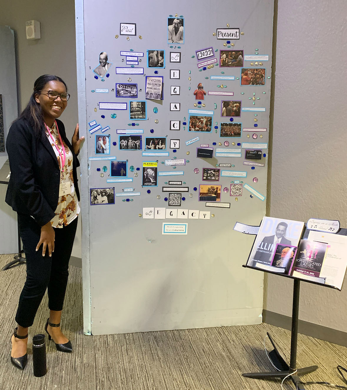 Nya Johnson smiles standing next to her winning display board at the festival.