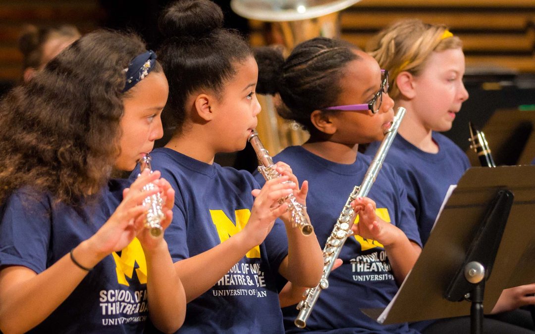 Elementary band students in SMTD t-shirts perform a recital