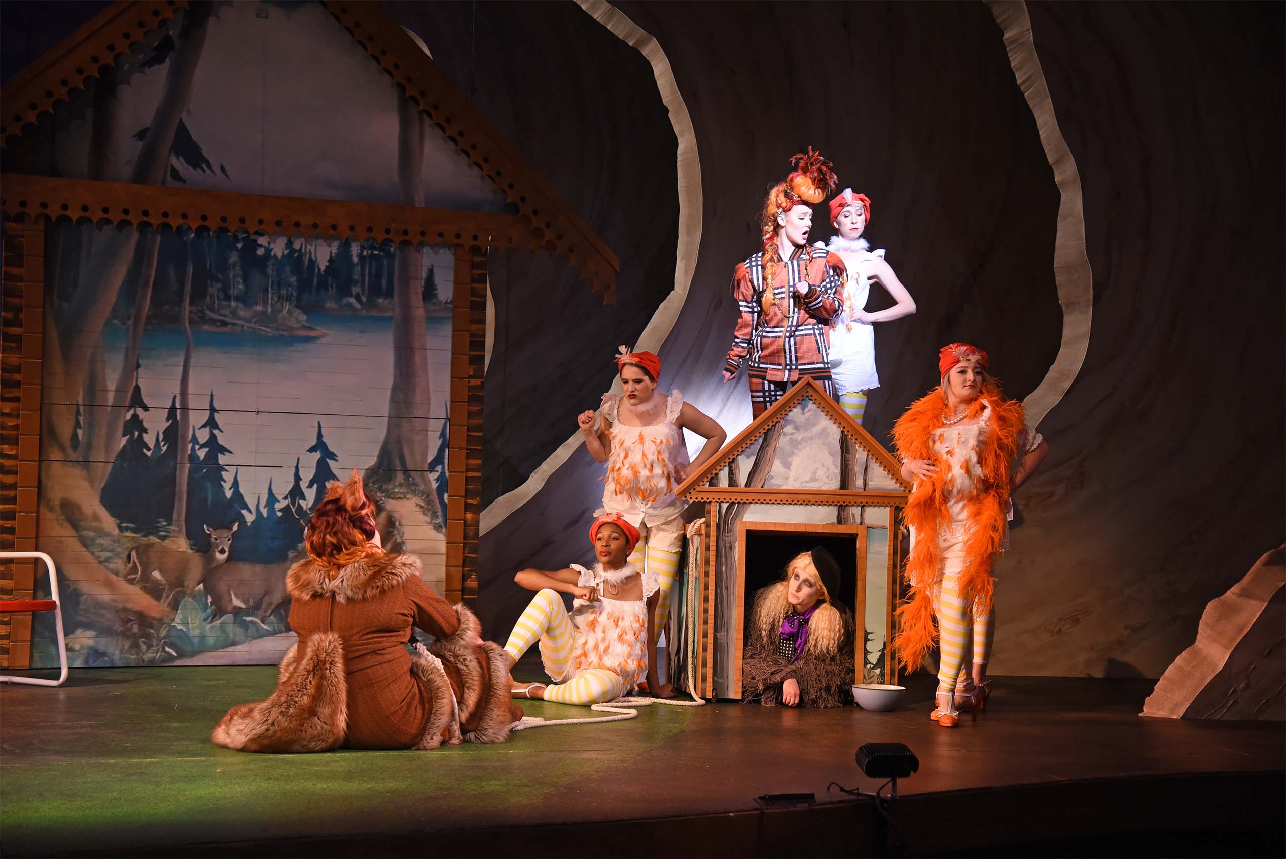 Opera performers on stage costumed as a fox and barnyard animals