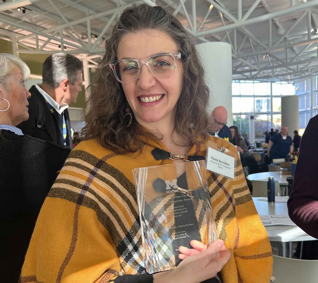 Paola Savvidou holds up the committee's engraved glass MHealthy Award