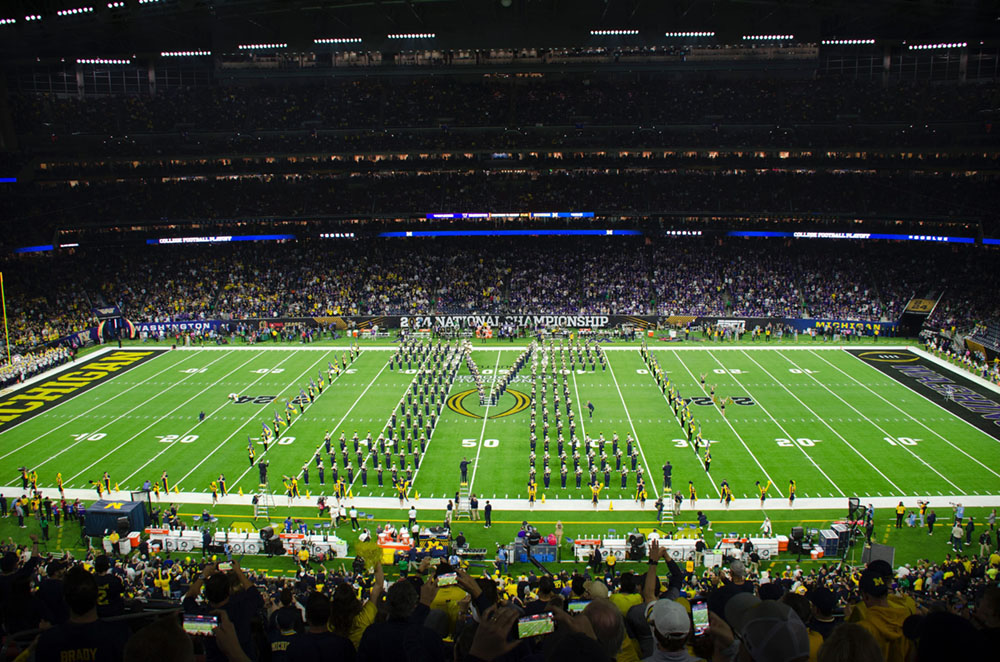 Michigan Marching Band in Block M formation on the field of the national championship in Houston