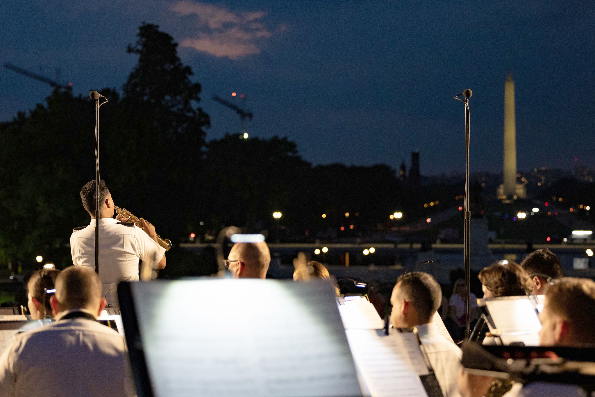 A view towards the Washington Monument with a military ensemble and trumpet soloist in the foreground