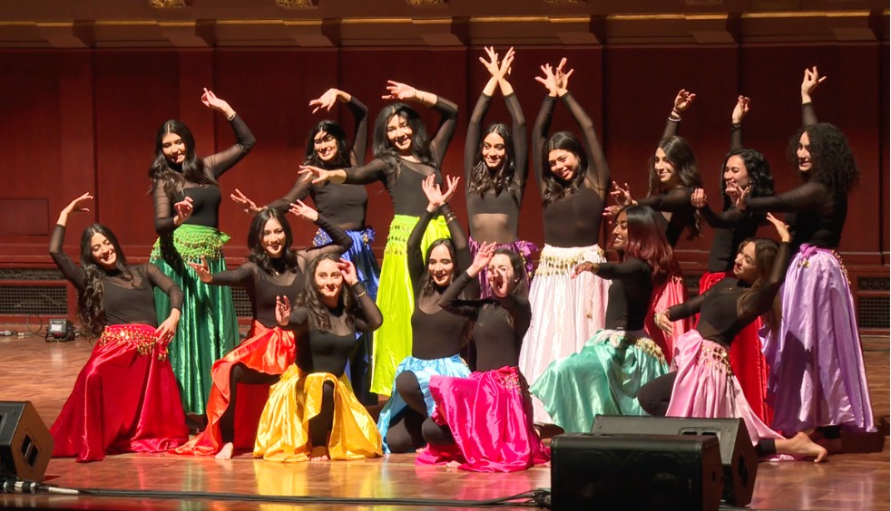 Persian Student Association group pose on stage.