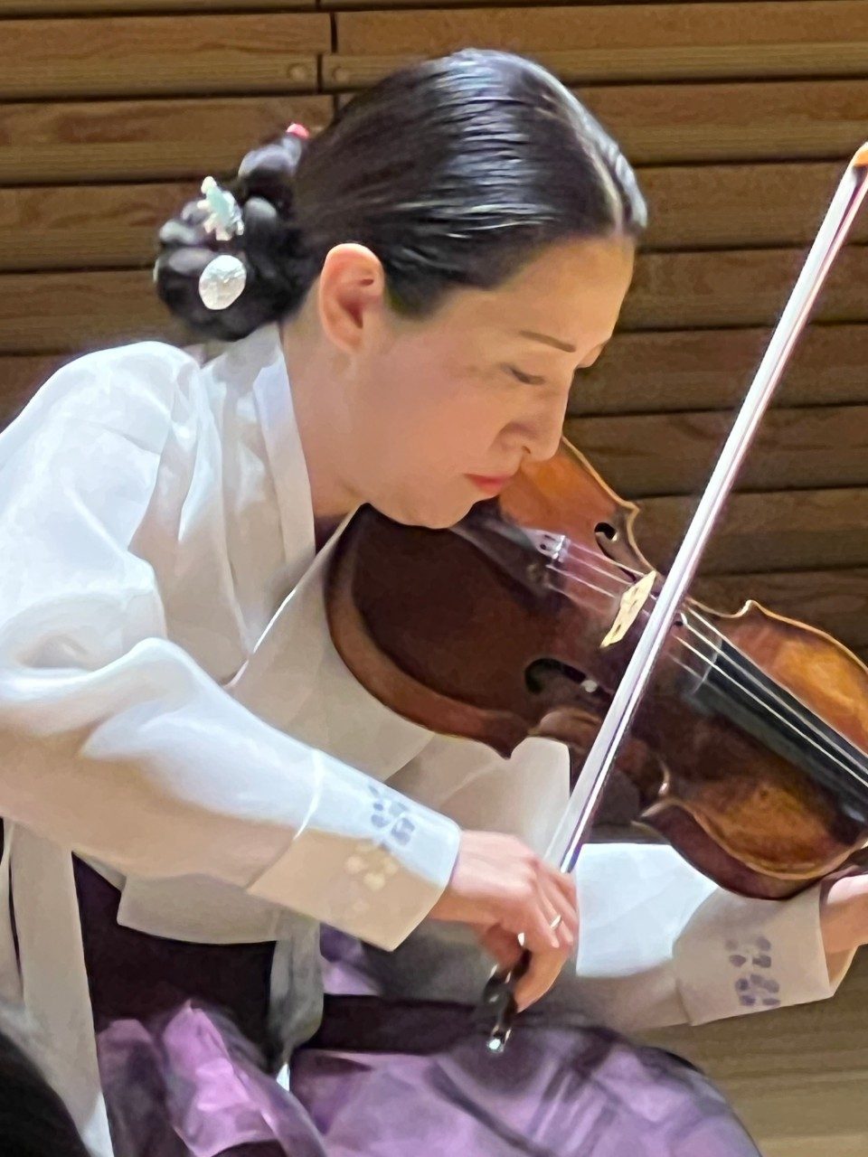 Soh-Hyun P. Altino performs on violin wearing traditional Korean dress