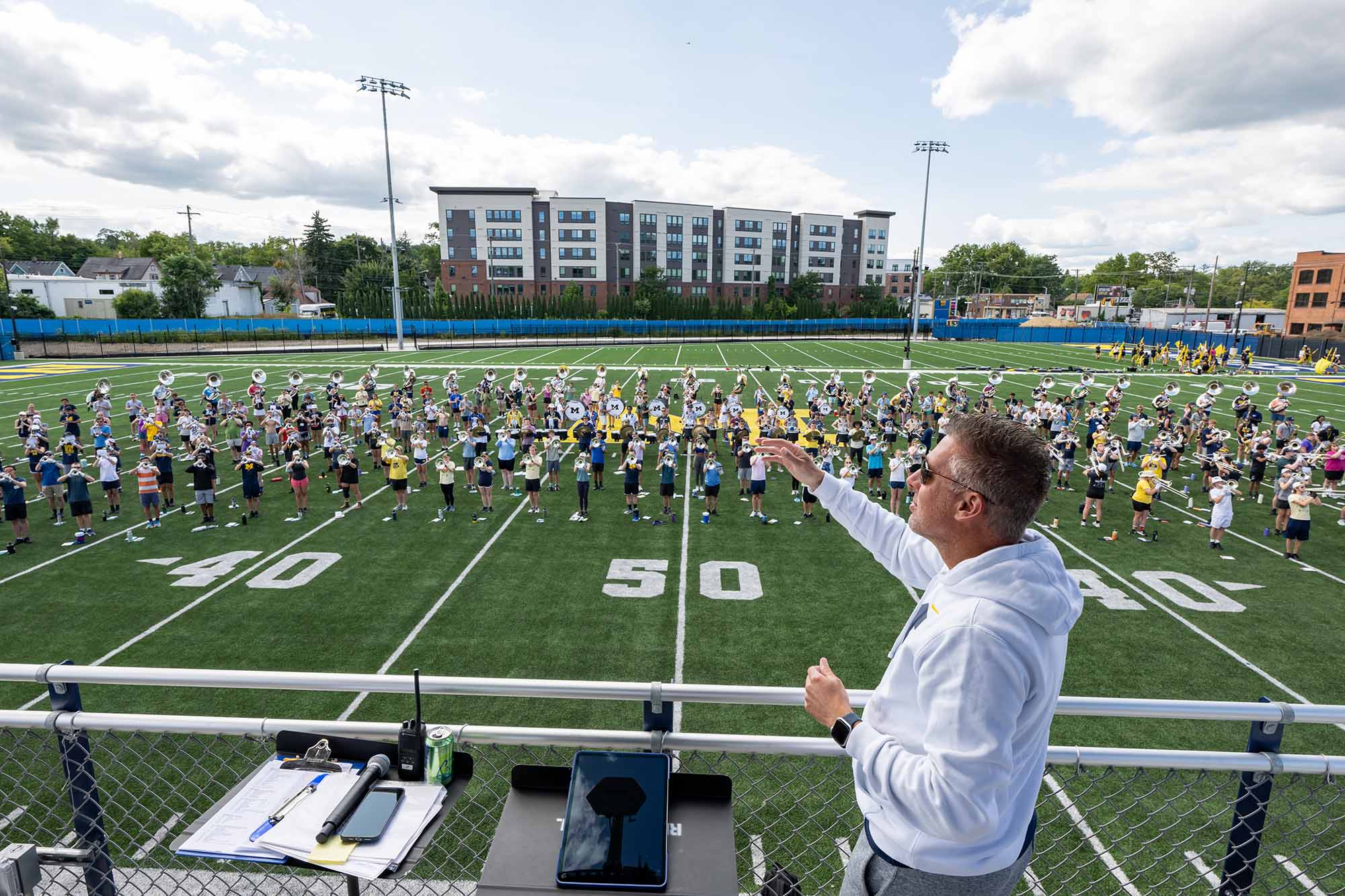 John Pasquale points out over the new Elbel Field as the marching band rehearses in formation