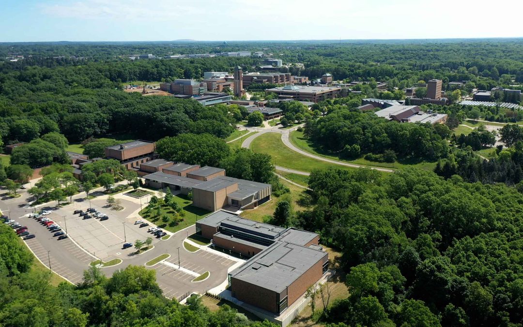 Aerial photograph of North Campus with Moore/ Dance buildings in the foreground and other buildings beyond; the trees are full of leaves