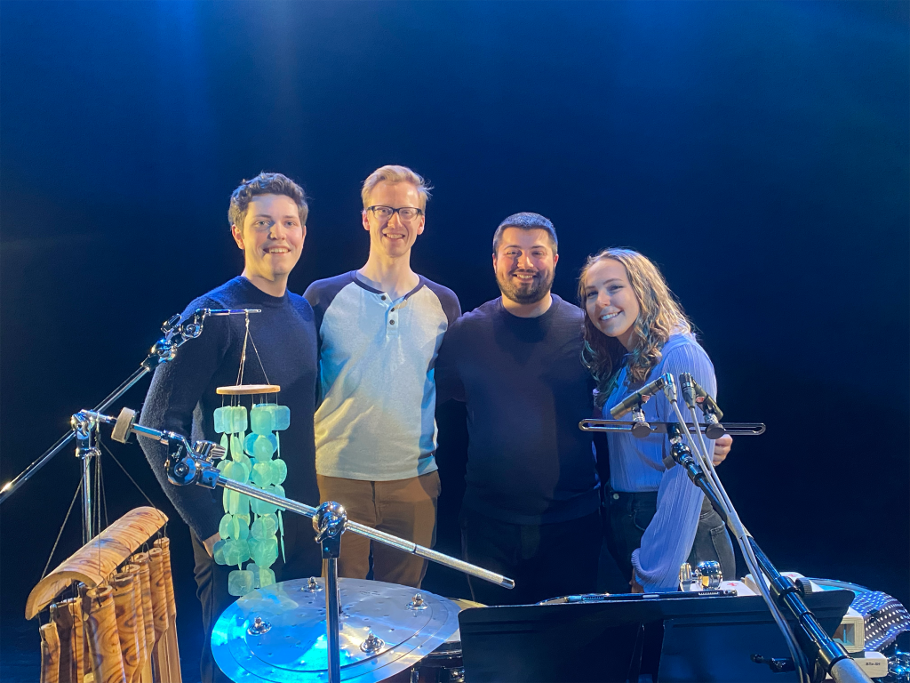 Brain Pocket, a percussion trio consisting of Jimmy Stagnitti, Olivia Cirisan, and Ancel Neeley, standing with Micah Mooney, a music theory student