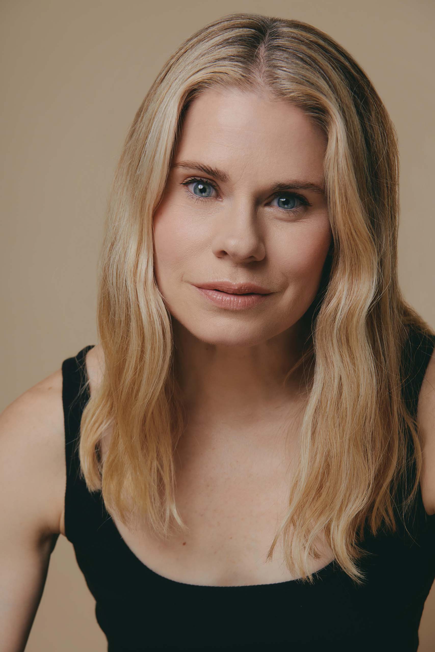celia-keenan-bolger Studio headshot of Celia Keenan-Bolger wearing a black tank top, with tan backdrop.
