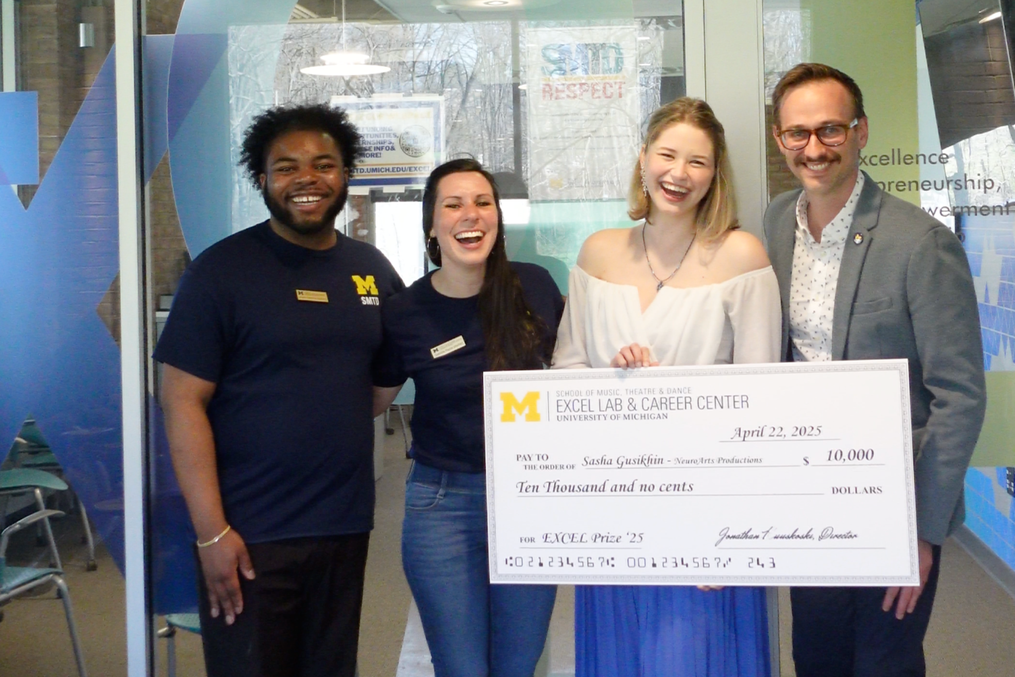 EXCEL Website Images-4 EXCEL Staff with 2023 EXCEL Prize winner, Lydia Bangura, who holds a large check