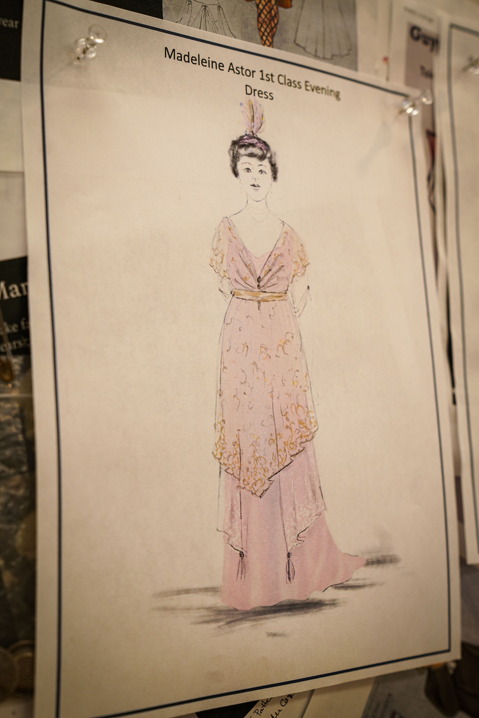 2a costume rendering Mrs Astor Titanic designer Suzanne Young A sketch of an evening gown costume on paper, colored with pink.