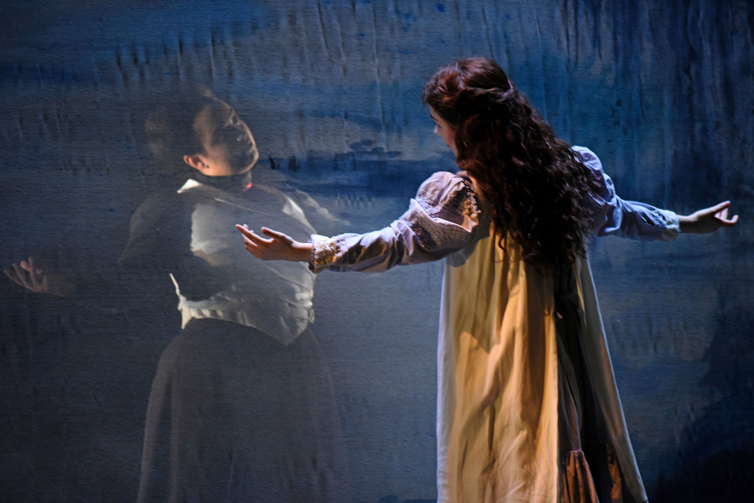 Theatrical Shops Overview The Turn of the Screw Mendelssohn Theatre 2025 A character on stage mirrors a ghostly figure behind a screen, with both dressed in Victorian era costume.