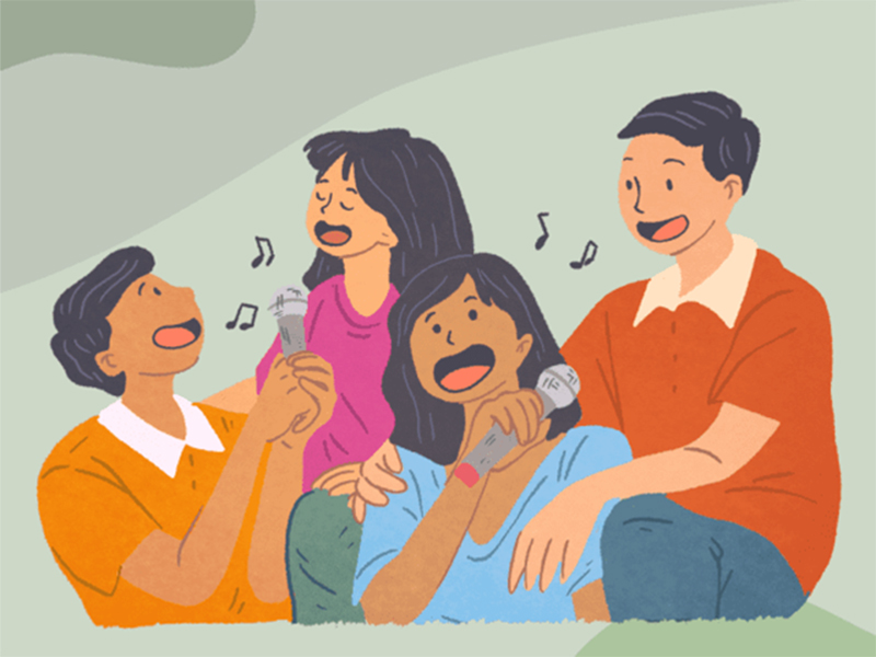 Four friends singing together in a group.