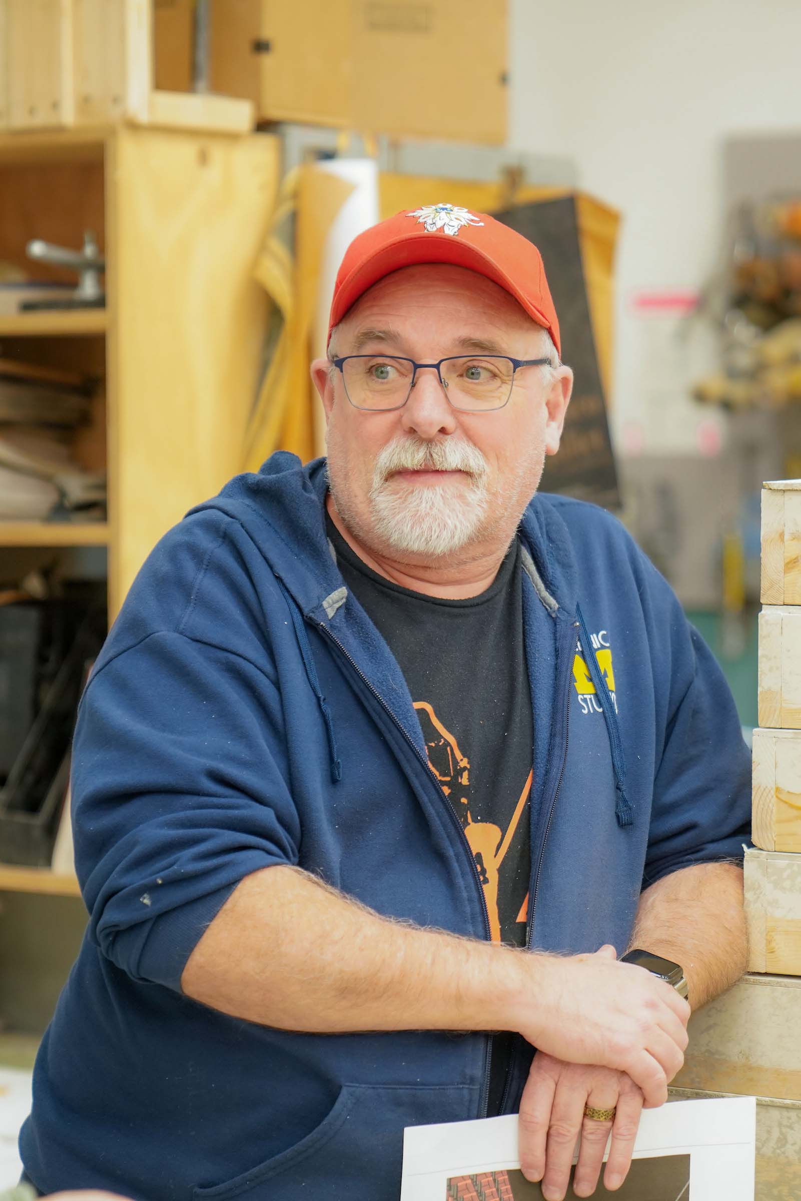 5 Rich Lindsay Walgreen Scene Shop Candid photo of Rich Lindsay at work in the scene shop, casually attired in a U-M hoodie.