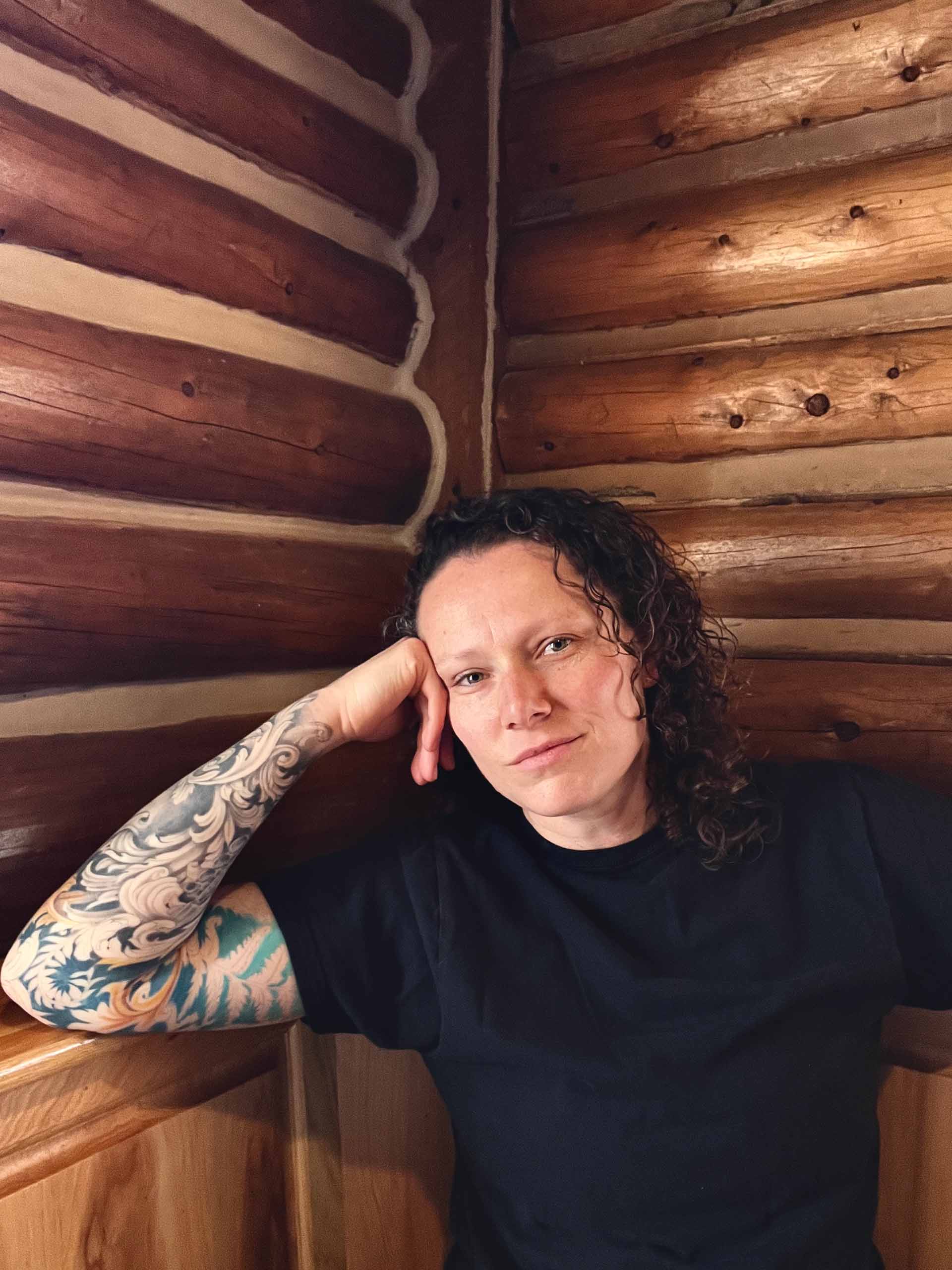 Casual portrait of Annika Socolofsky with log walls in the background.