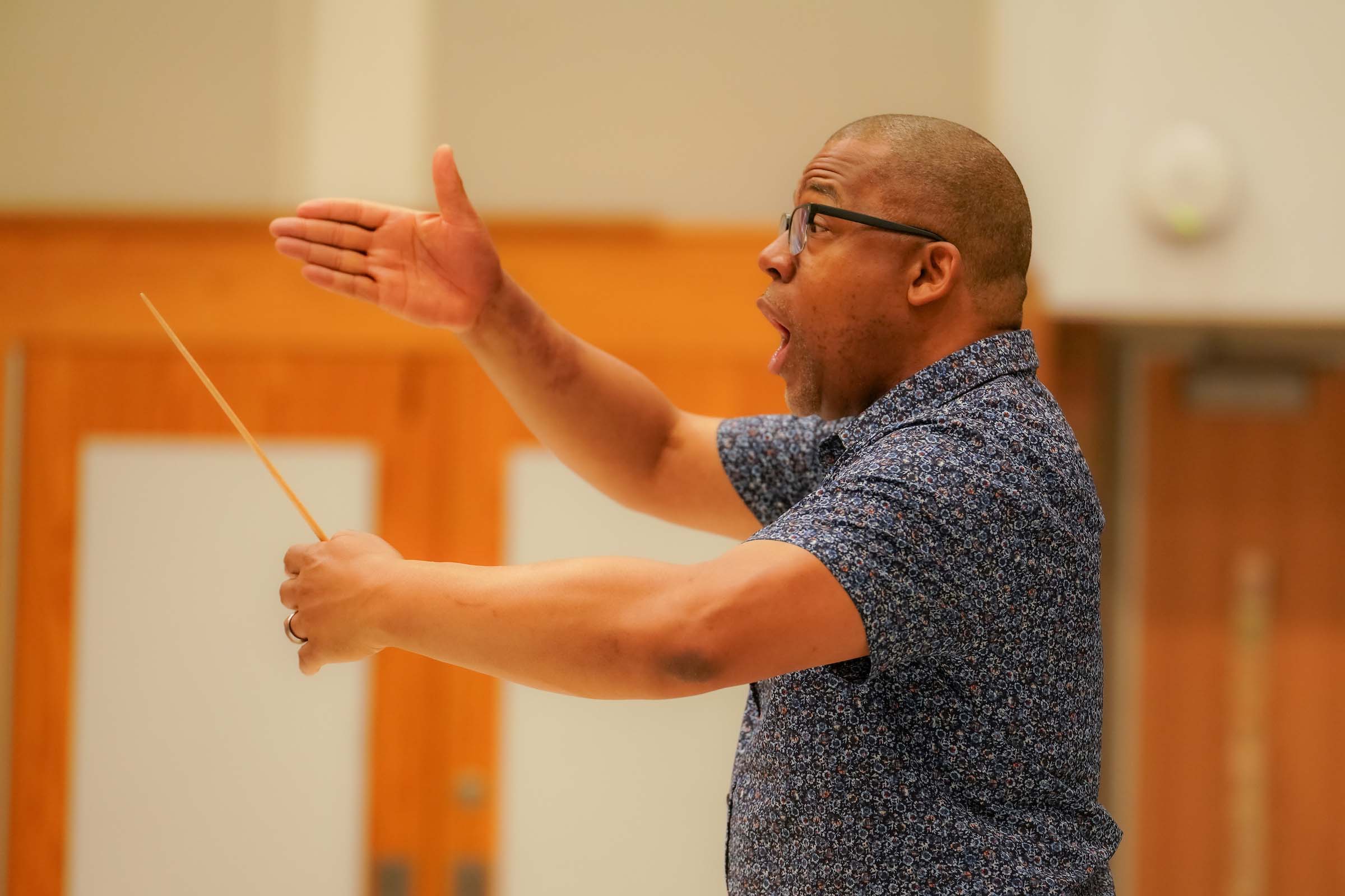 Eugene Rogers conducts a choral rehearsal.