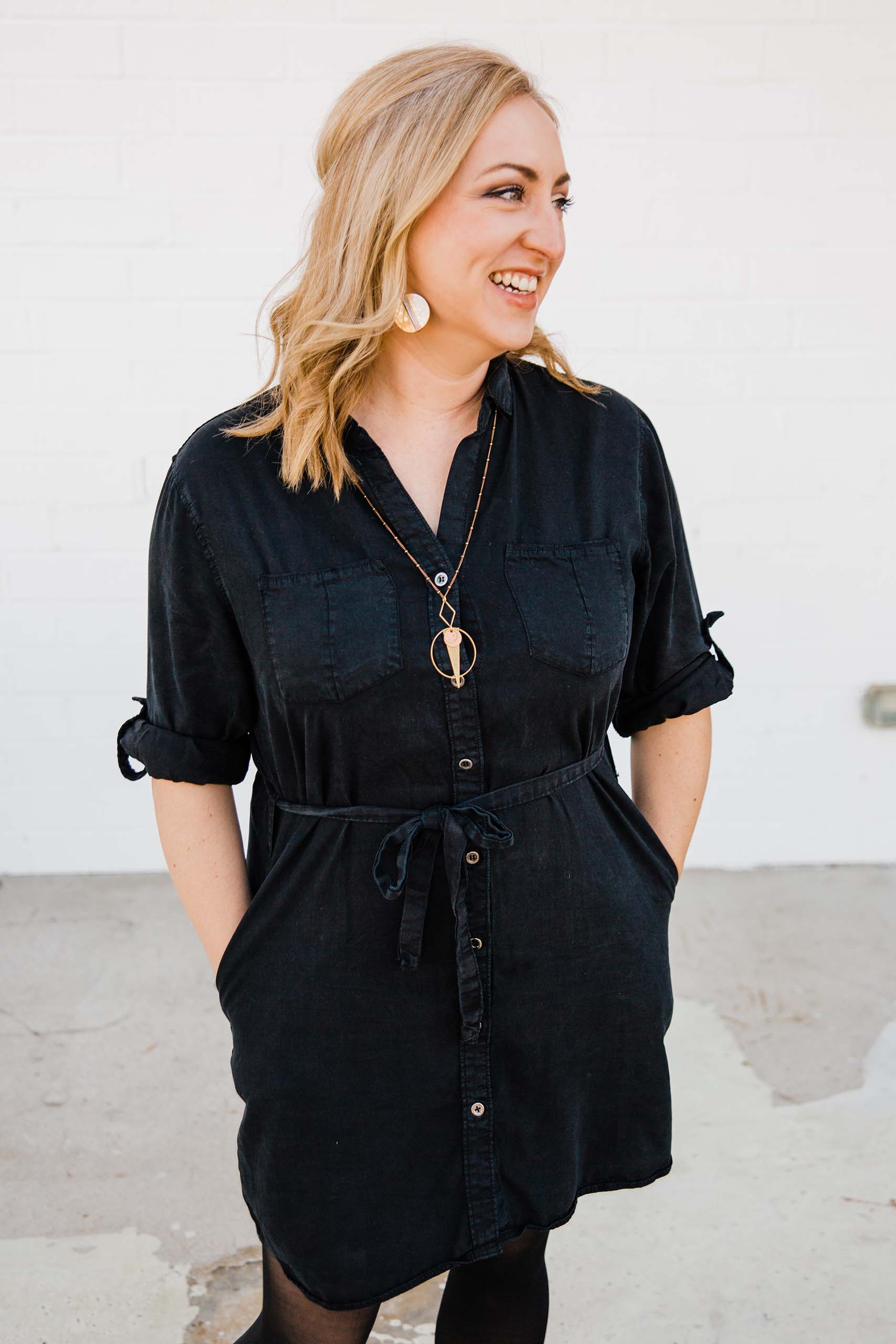 Candid portrait of Jani Parsons standing with her hands in her pockets.