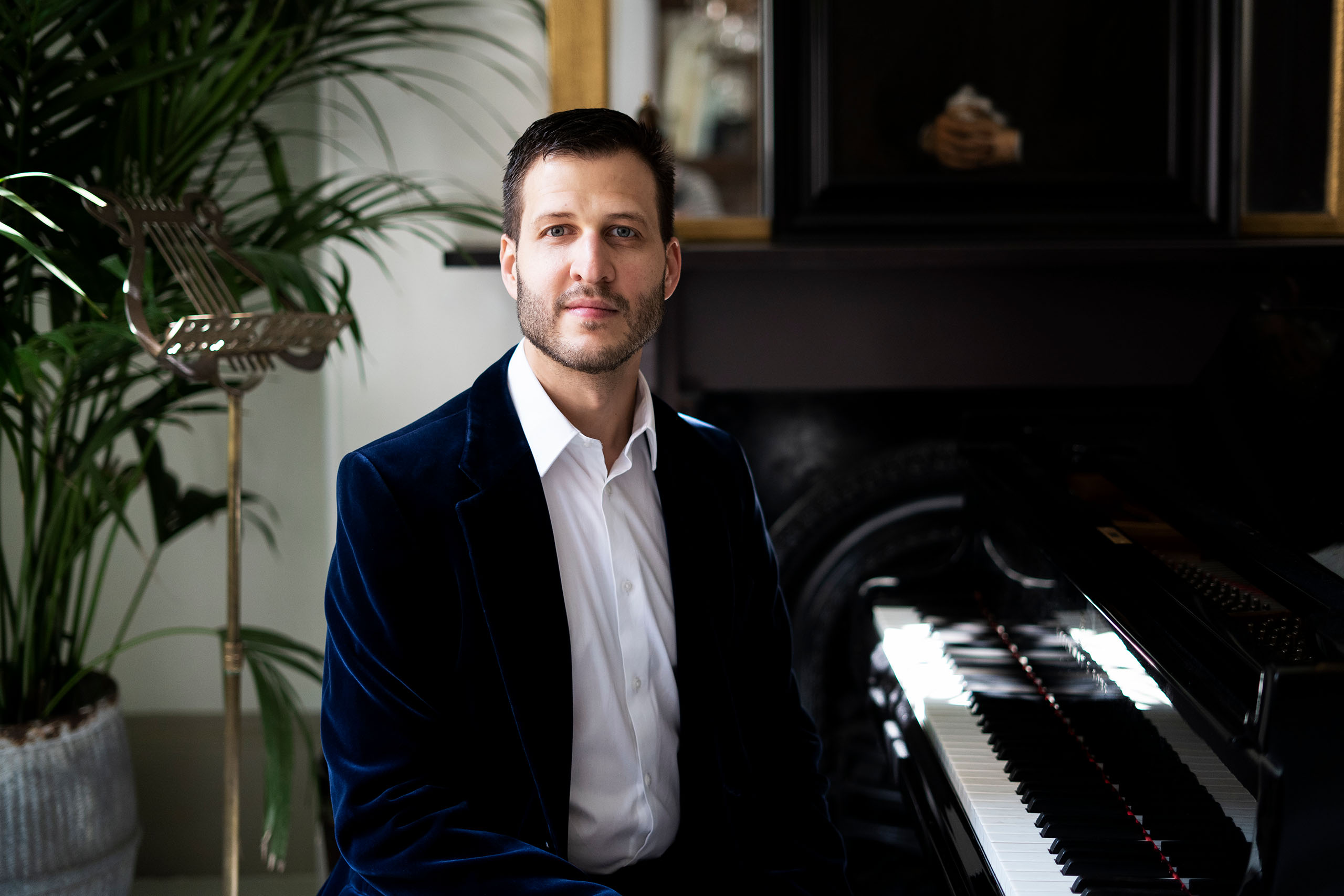 Portrait of Nico de Villiers  seated at a piano.