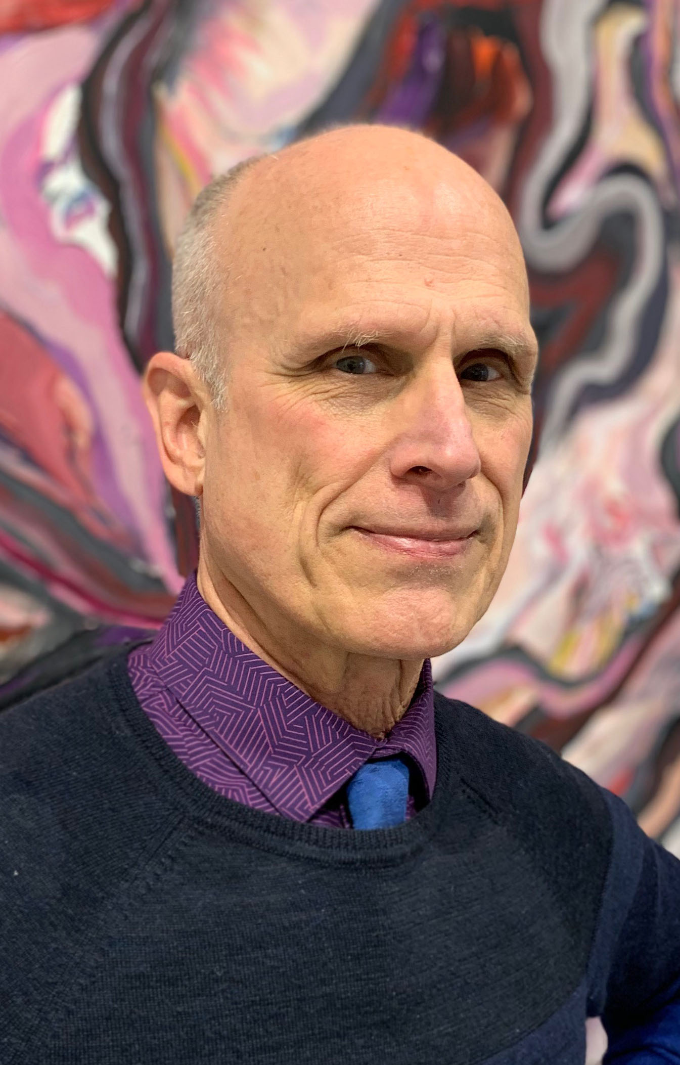 Headshot of Peter Sparling with abstract swirling artwork in the background