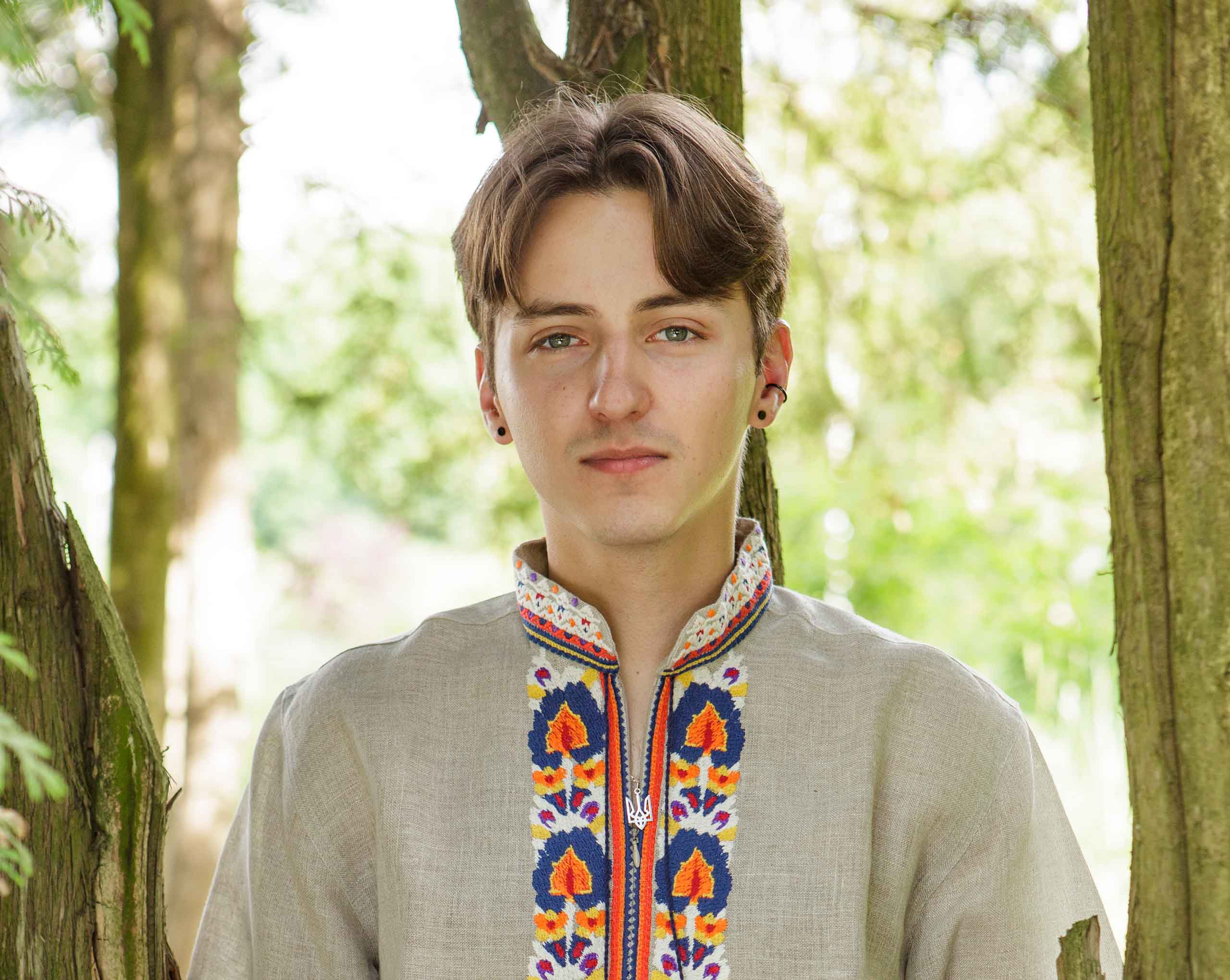 Portrait of Anton Greene taken outdoors in a forest.