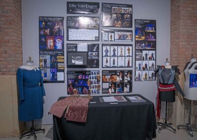 Ellie Van Engen’s display featuring sketches, costume models, and production photos.
