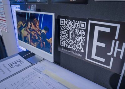 A dance production photo and QR code leading to Hoffman’s portfolio.