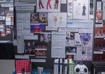 Greta Steever’s display featuring costume sketches, rendering examples, and production binders.