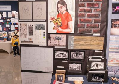 Hannah Kryzhan’s display featuring paintings, set models, and blueprints.