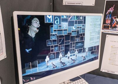 Digital display playing videos from Comini’s work on Matilda.