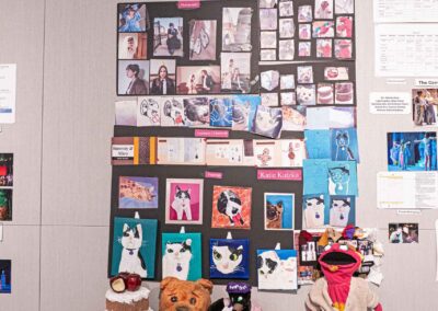 Katie Kutzko’s display featuring props, paintings, and production photos.