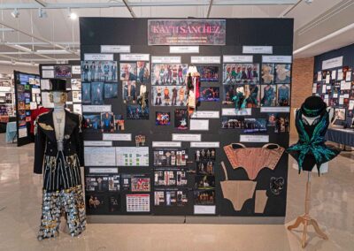 Kayti Sanchez’s display featuring costume sketches, models, and production photos.