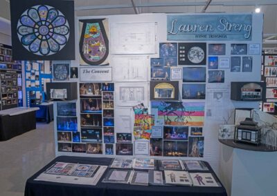 Lauren Streng’s display featuring set models, blueprint sketches, and production photos.