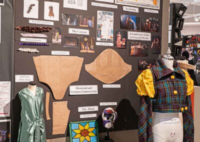Rachel Pfeil’s display featuring costume sketches, construction examples, and production photos.