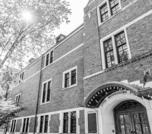 Exterior of the historic, brick Mendelssohn Theatre with a tree rising above.