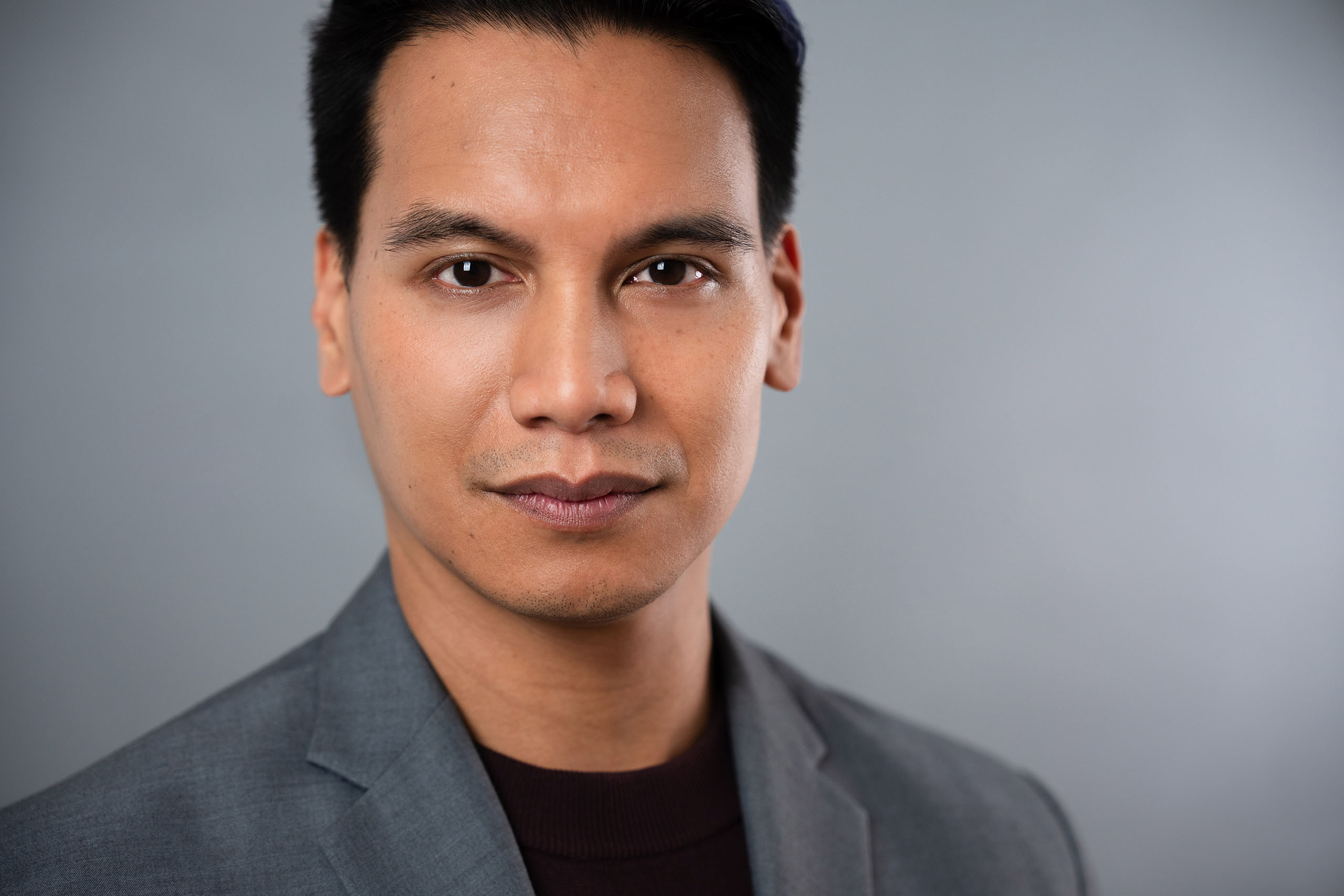 Studio headshot of Darryl Semira in a grey suitcoat.