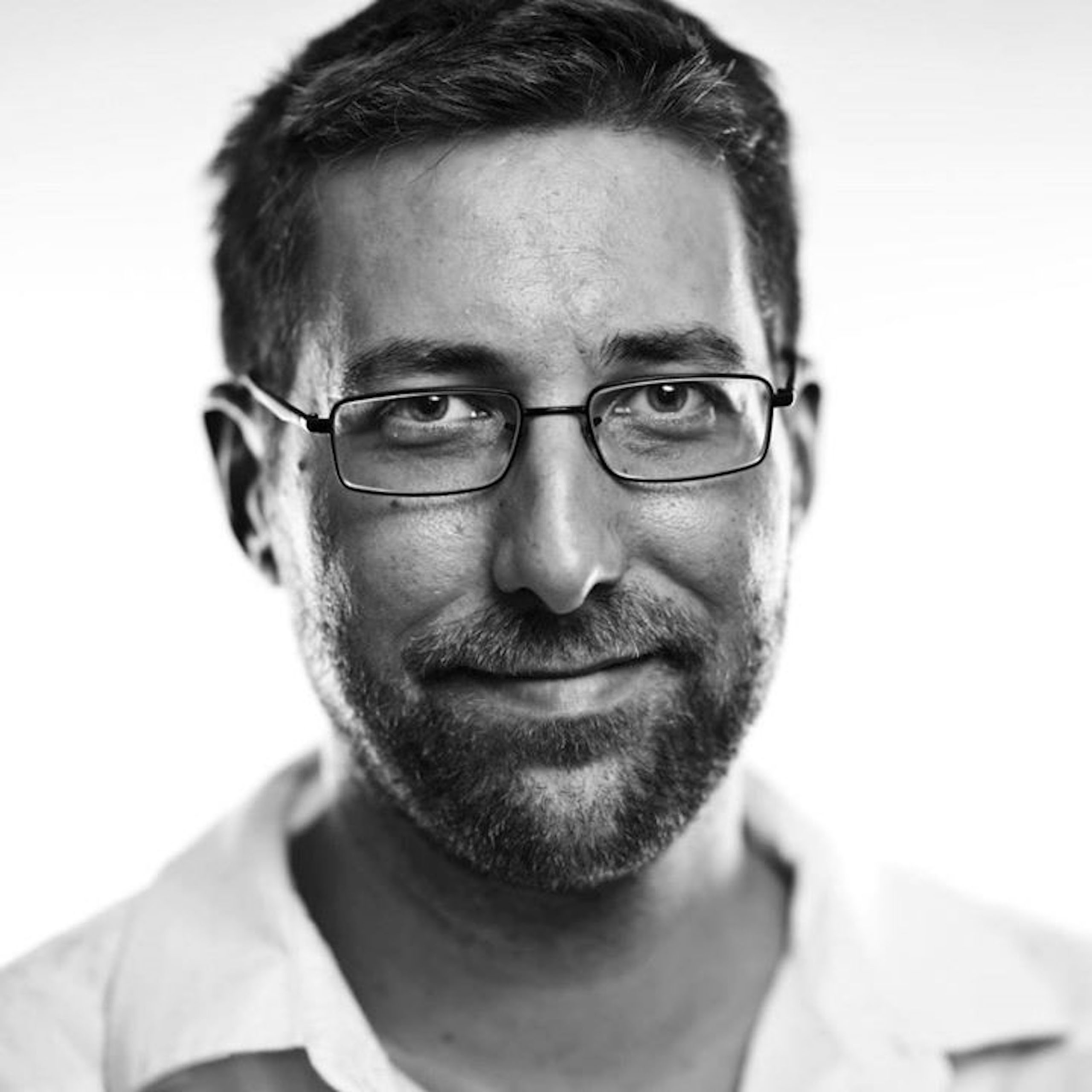 Greyscale studio headshot of John Churchville.