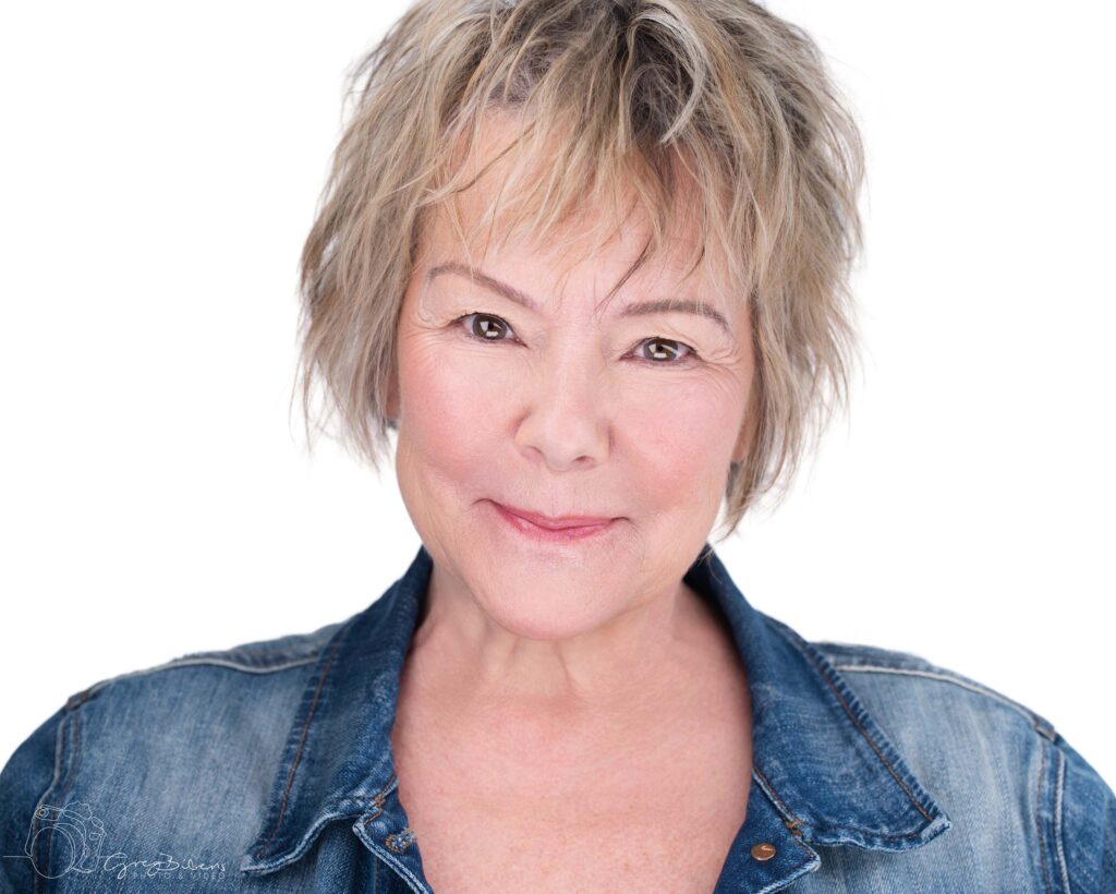 Studio headshot of Judy Rice, wearing a jean jacket.