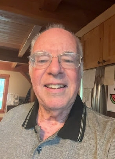 Casual headshot of Lawrence Bell with wood cabinets and ceiling in the background.