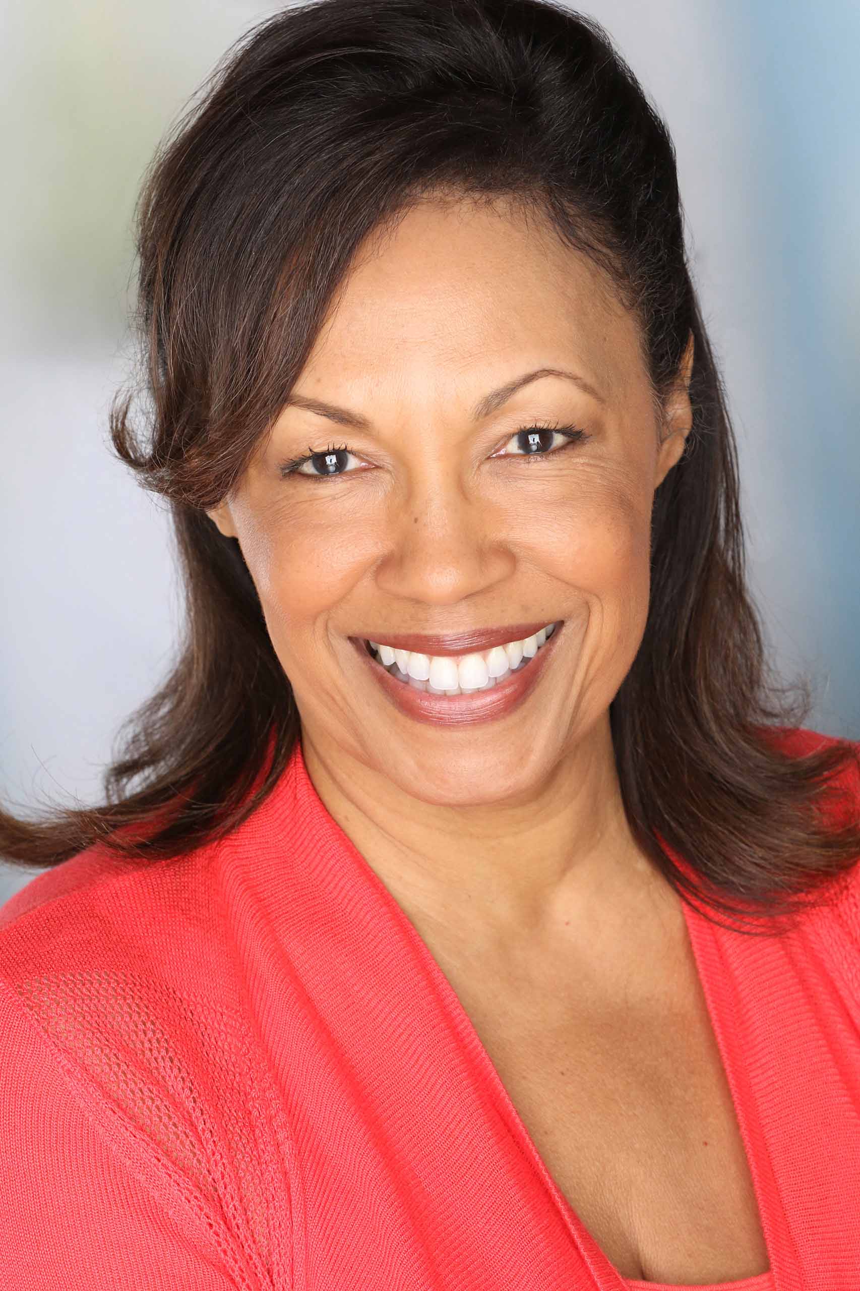 Studio headshot of Marjorie Mann, wearing a salmon-colored blouse.