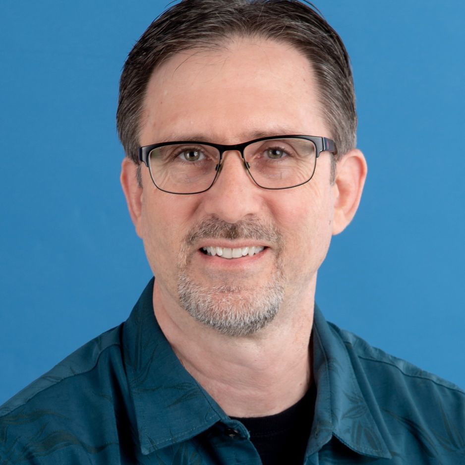 Studio headshot of Michael Mazzatenta in a blue collared shirt.