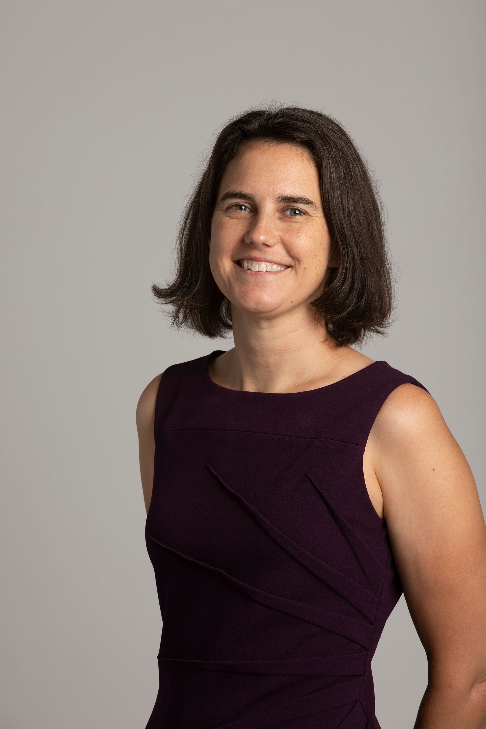 Formal studio portrait of Sarah Gerk standing. 